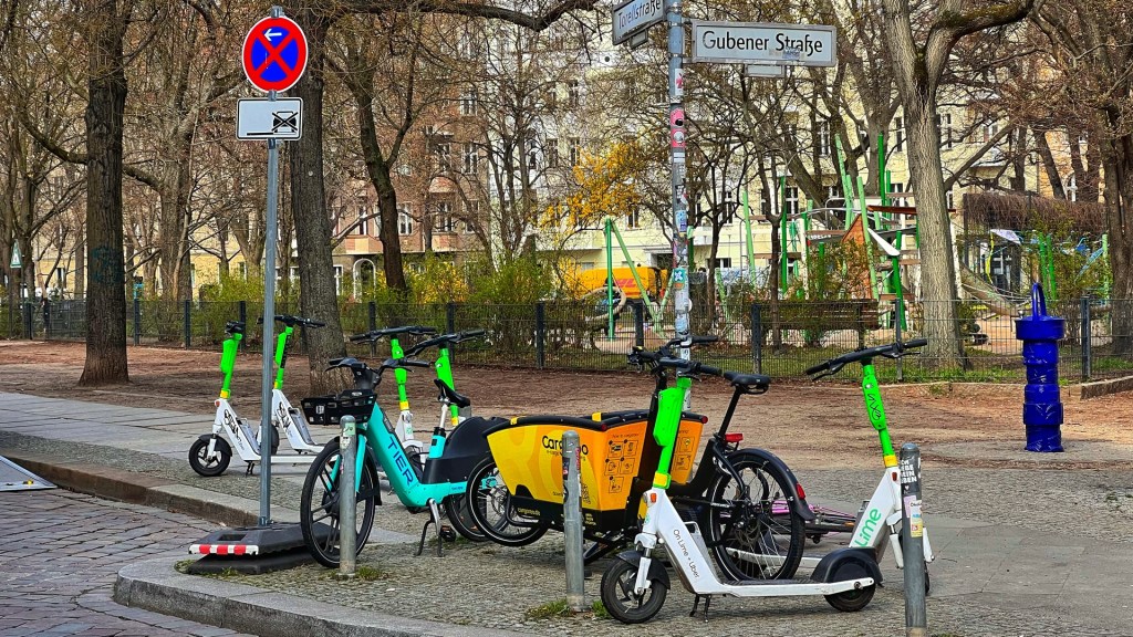 E-Scooter, Leihfahrrad und Lastenrad stehen auf einem Bürgersteig