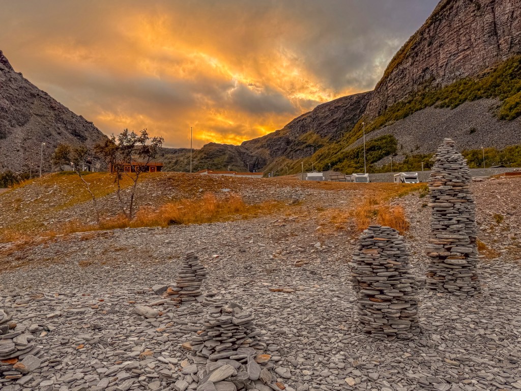 Steintürmchen in Norwegen vor einem Sonnenuntergang