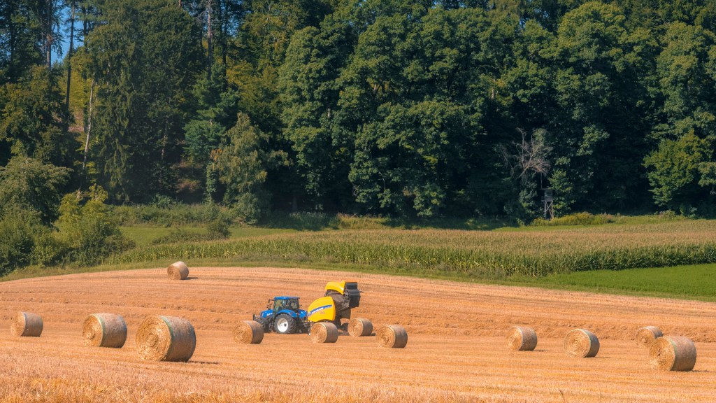 Trecker mit Anhänger erzeugt Strohballen